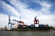 shipping containers and cranes on a barge