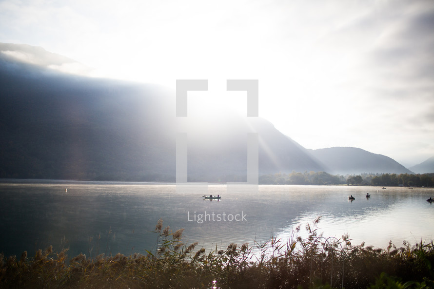 rays of morning sunlight on a lake in France 