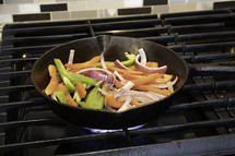 peppers and onions in a skillet 