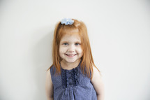 portrait of a cute red-headed little girl.