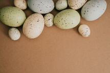 speckled Easter eggs on a brown background, 