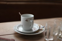 spoon in a coffee cup on a saucer 