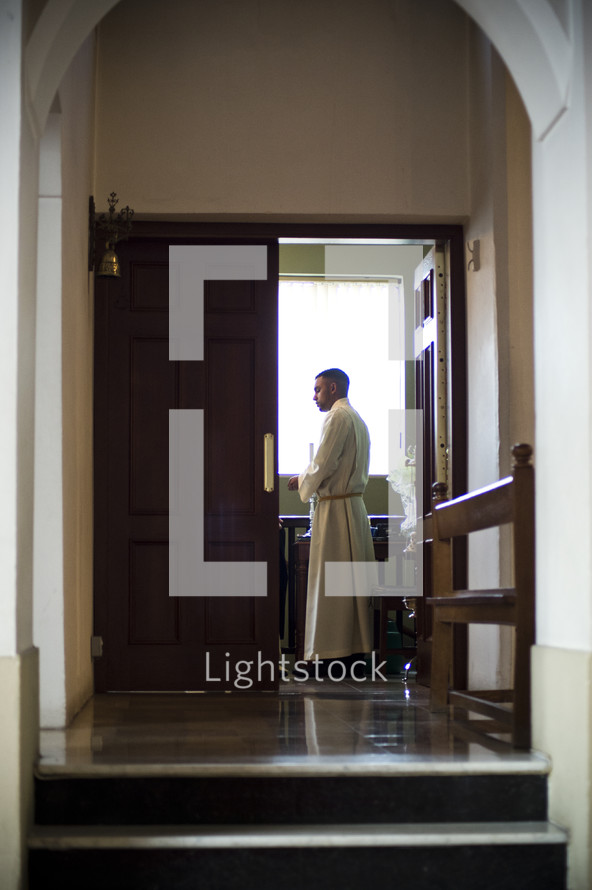 Priest in the sacristy.