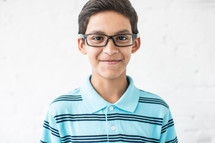 boy child with a smirk and reading glasses 
