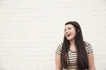 a joyful young woman laughing.