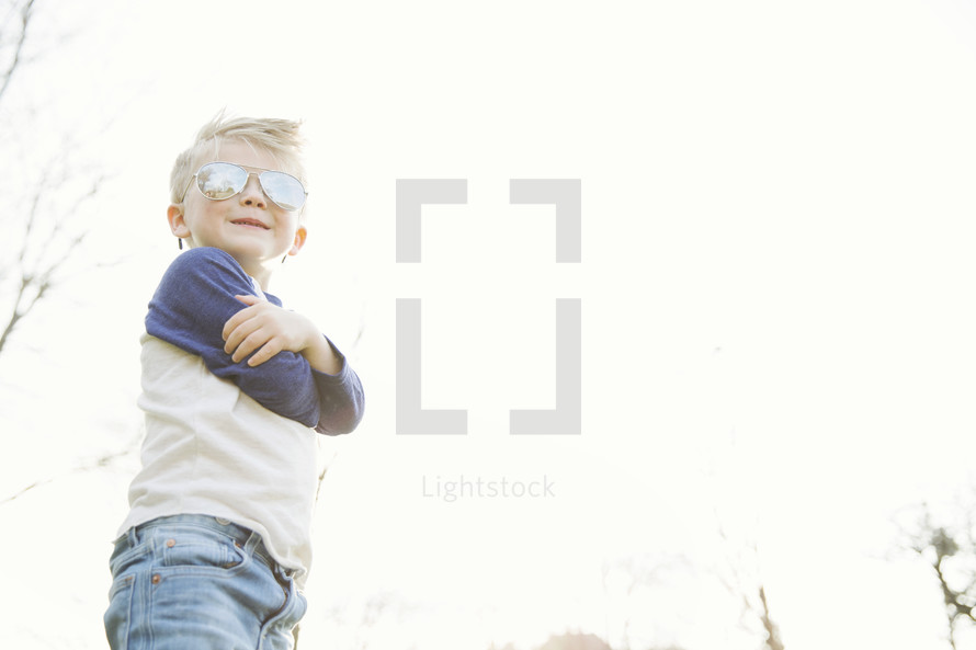 young boy outdoors in sunglasses 
