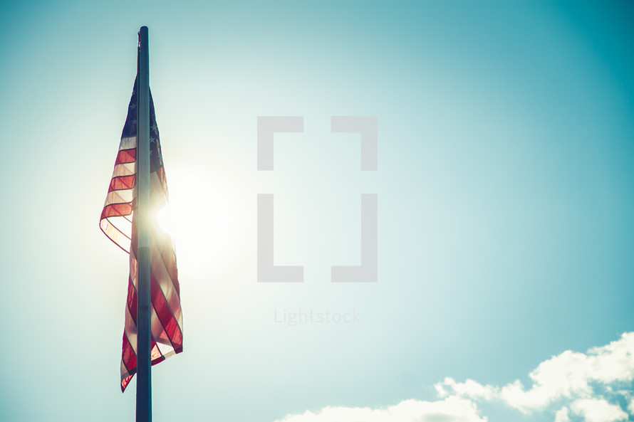 sunlight shining on an American flag 