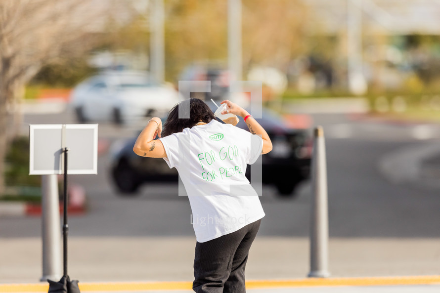 teen dancing wearing a t-shirt that reads For God For People 