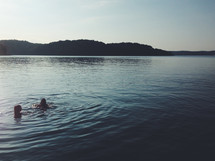girls swimming in a lake 