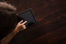 woman touching an iPad screen 