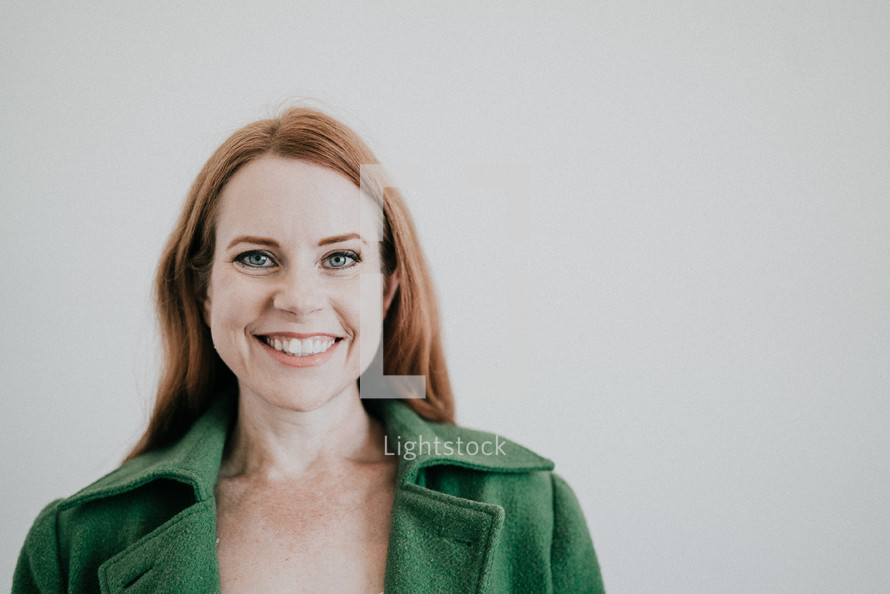 woman in a green blazer smiling 