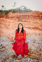 women in a red dress in a desert 