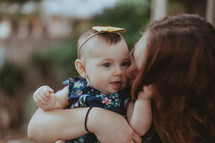 an aunt kissing her infant niece 