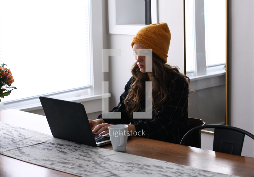a woman working on a laptop computer 