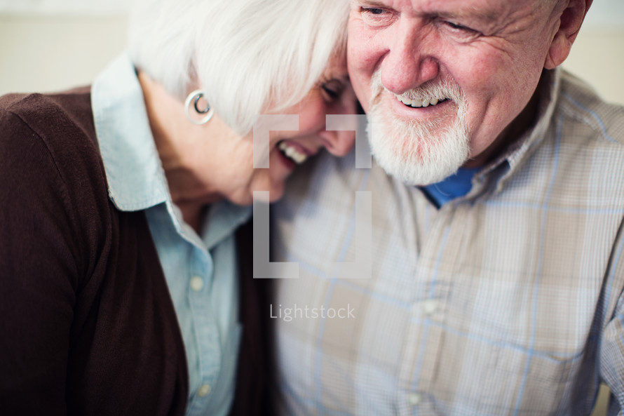 a mature couple laughing together. 