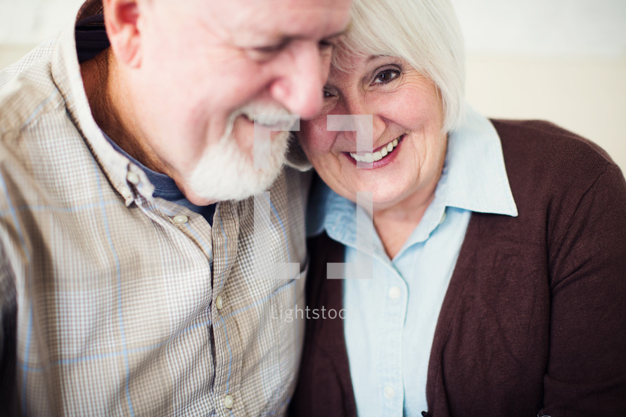 an elderly couple snuggling 