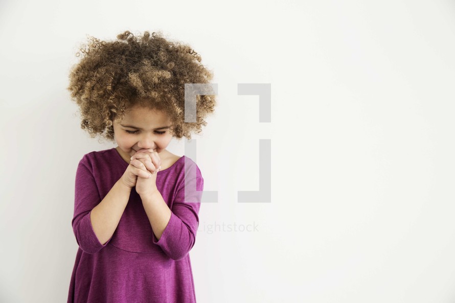 girl child with praying hands