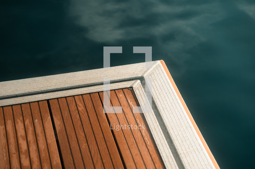 Jetty decking, marina floor, sea lake water coastal structure, geometric wooden panels with metal strip. Minimalistic boating marine photography