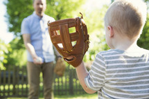 father and son throwing a baseball 