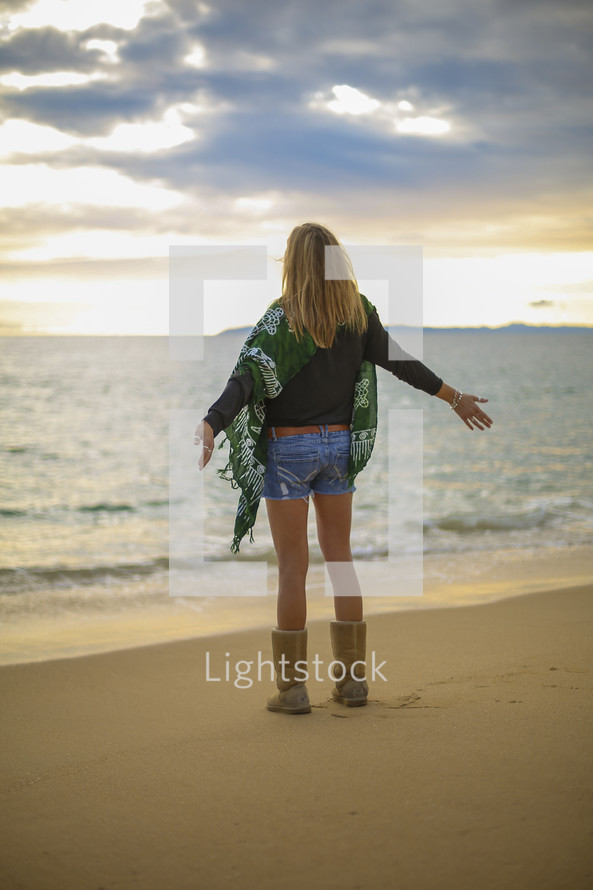 woman with open arms on a beach 