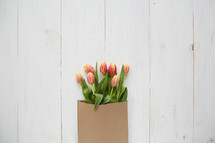 spring tulips in a brown paper bag 