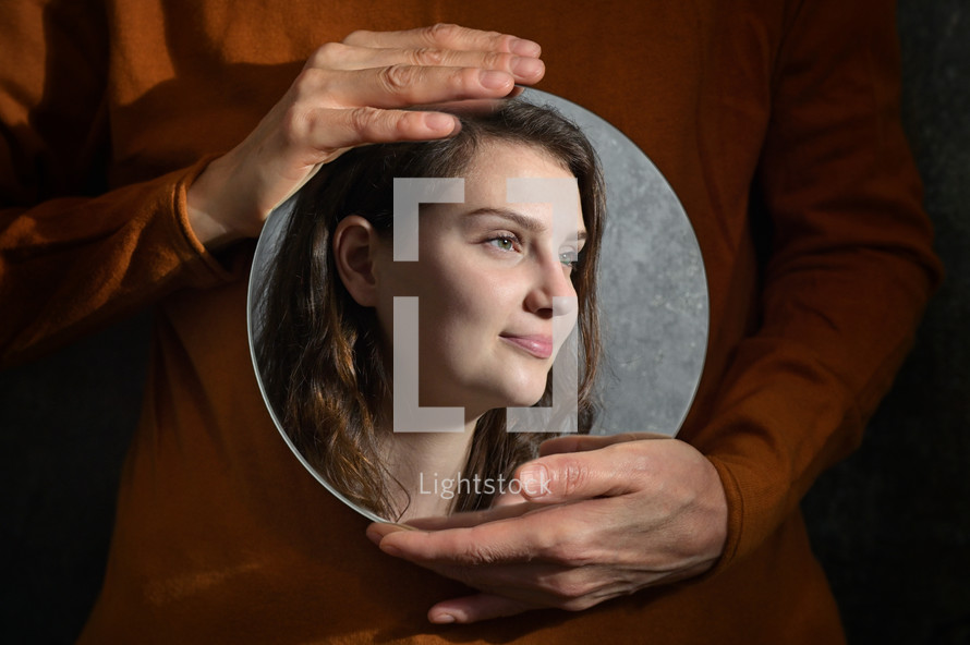 Conceptual Mother Holding A Mirror And Reflexion of Daughter