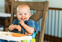 messy toddler in a highchair 
