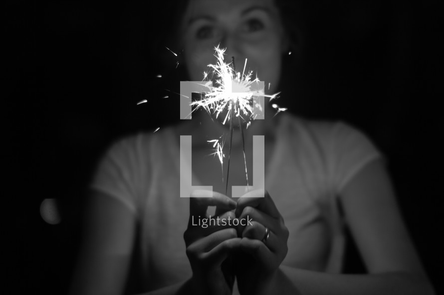woman holding a sparkler