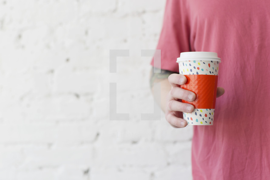 man holding a coffee cup 