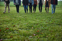 group walking in a field of grass in fall
