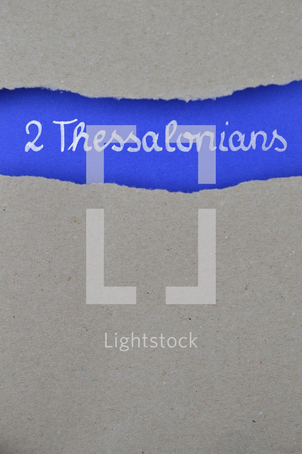 2 Thessalonians - torn open kraft paper over intense blue paper with the name of the second letter from Paul to the Thessalonians