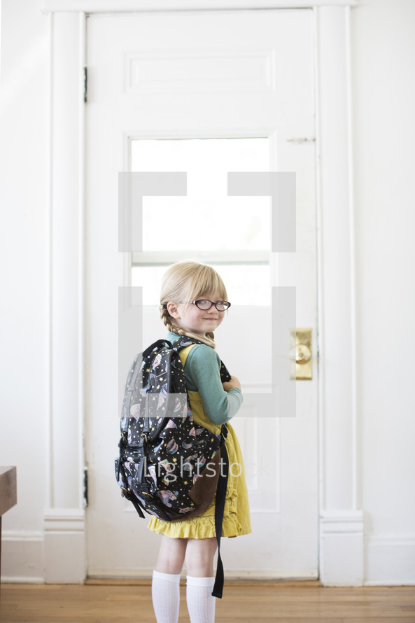 girl child standing at a door - first day of school 