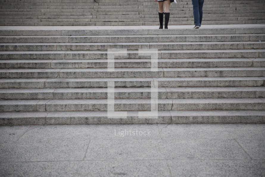 legs on stone stairs 