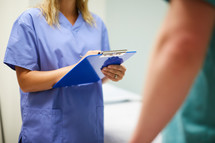a nurse holding a clipboard 