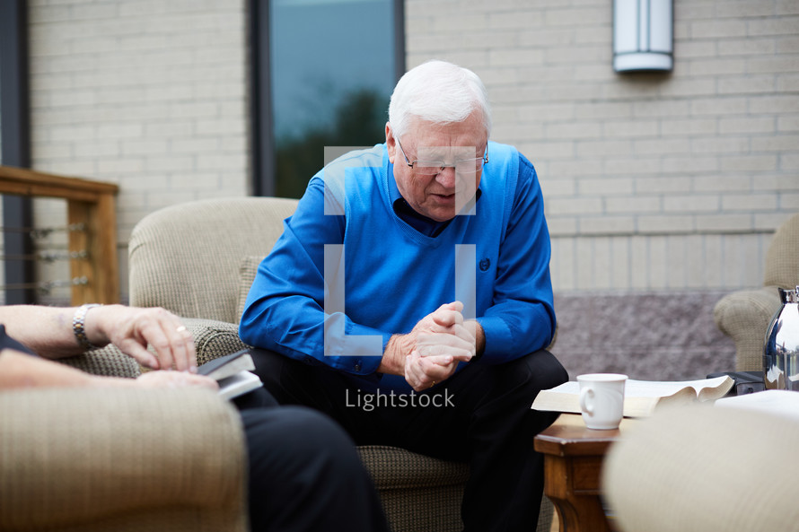 senior men's Bible study praying 