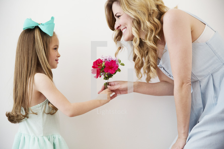 a daughter giving mother flowers.