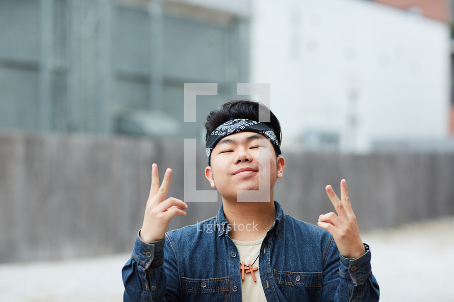 young man showing peace signs 