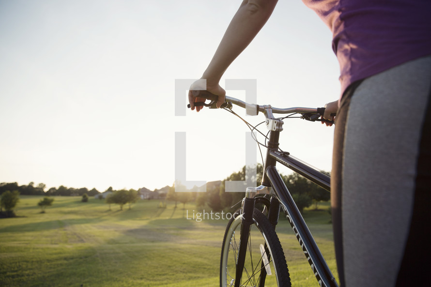 woman getting ready to ride a bicycle in the country.
