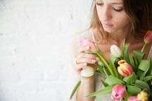 a woman holding a bouquet of tulips 