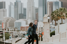 couple walking in a city with palm trees