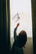 Innocence and Hope: A 4-Year-Old Girl Waving the Israeli Flag