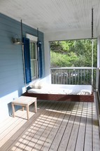 swinging day bed on a porch 