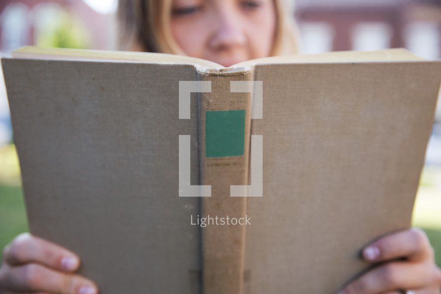 woman reading a Book outdoors 
