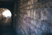 brick wall in a dark tunnel 
