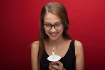 a young woman holding a candle 