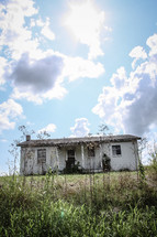 Dilapidated house in a field.