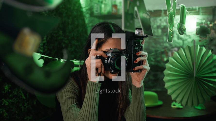 Girl takes pictures with camera in a party