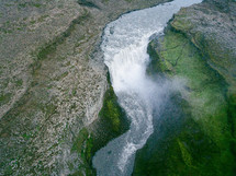 waterfall and river flowing through a canyon 