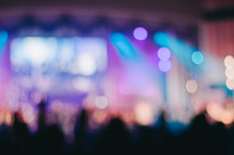 blurry image of an audience at a concert 