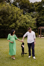 expecting couple and dog 